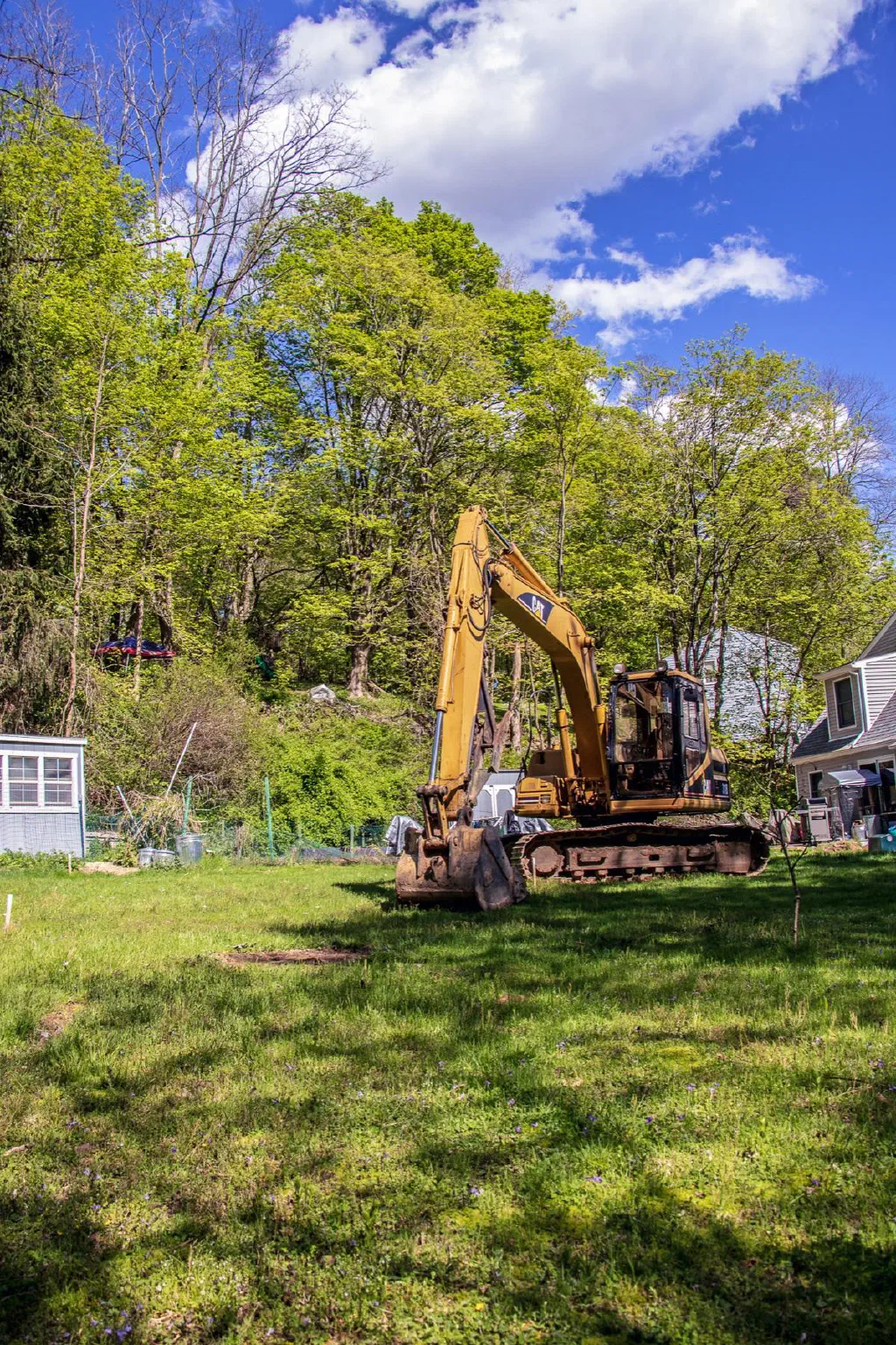 Snow Septic Repair excavator on a residential job site