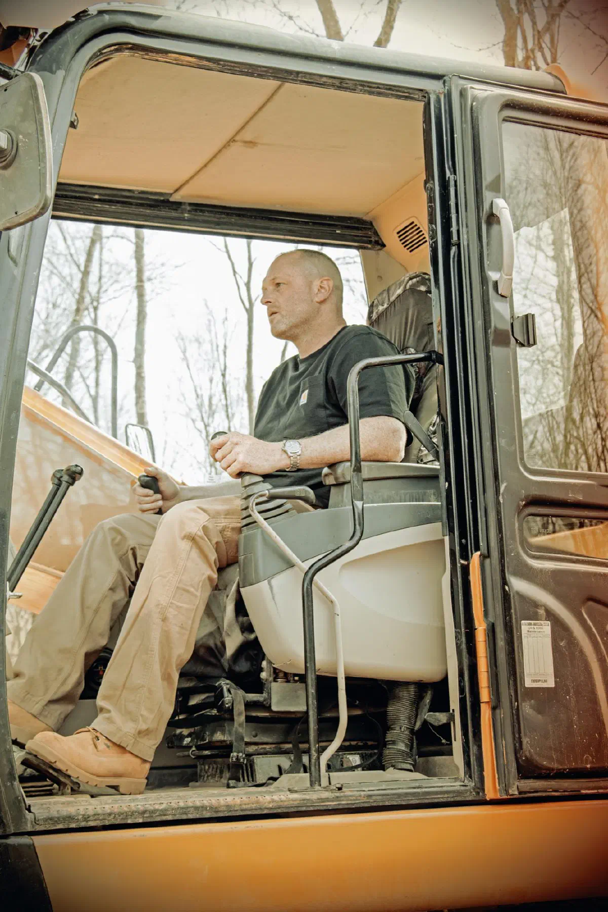Mark Snow at the controls in the cab of an excavator